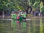 Emergency services personnel evacuate stranded residents from a flooded colony after heavy rainfall owing to Cyclone Michaung at Mylapore in Chennai, on Wednesday. Emergency services personnel evacuate stranded residents from a flooded colony after heavy rainfall owing to Cyclone Michaung at Mylapore in Chennai, on Wednesday.