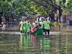 Emergency services personnel evacuate stranded residents from a flooded colony after heavy rainfall owing to Cyclone Michaung, at Mylapore in Chennai, on Wednesday. (PTI)