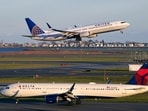FILE - A United Airlines jet takes off while a Delta Airlines plane taxis at Logan International Airport, Monday, Nov. 21, 2022, in Boston. (AP Photo/Charles Krupa, File) FILE - A United Airlines jet takes off while a Delta Airlines plane taxis at Logan International Airport, Monday, Nov. 21, 2022, in Boston. (AP Photo/Charles Krupa, File)