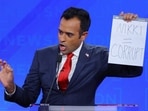 Republican presidential candidate and businessman Vivek Ramaswamy holds up a handwritten sign referring to fellow candidate and former U.S. Ambassador to the United Nations Nikki Haley as he speaks during the fourth Republican candidates' debate of the 2024 U.S. presidential campaign hosted by NewsNation at the University of Alabama in Tuscaloosa, Alabama, U.S. December 6, 2023. REUTERS/Brian Snyder