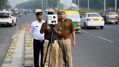 A traffic personnel uses a speed gun on Parthala Signature Bridge in Sector 122, Noida, to penalise speed limit violations. (Sunil Ghosh/HT Photo) A traffic personnel uses a speed gun on Parthala Signature Bridge in Sector 122, Noida, to penalise speed limit violations. (Sunil Ghosh/HT Photo)