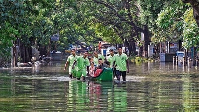 Emergency services personnel evacuate stranded residents from a flooded colony after heavy rainfall owing to Cyclone Michaung at Mylapore in Chennai, on Wednesday. (PTI) Emergency services personnel evacuate stranded residents from a flooded colony after heavy rainfall owing to Cyclone Michaung at Mylapore in Chennai, on Wednesday. (PTI)