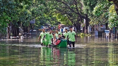 Emergency services personnel evacuate stranded residents from a flooded colony after heavy rainfall owing to Cyclone Michaung, at Mylapore in Chennai, on Wednesday. (PTI) Emergency services personnel evacuate stranded residents from a flooded colony after heavy rainfall owing to Cyclone Michaung, at Mylapore in Chennai, on Wednesday. (PTI)