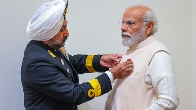 Prime Minister Narendra Modi receives a badge from Secretary, Kendriya Sainik Board Commodore HP Singh on the occasion of Armed Forces Flag Day in New Delhi. (PTI) Prime Minister Narendra Modi receives a badge from Secretary, Kendriya Sainik Board Commodore HP Singh on the occasion of Armed Forces Flag Day in New Delhi. (PTI)