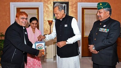 Congress leader Ashok Gehlot presents a grant to armed forces personnel on the occasion of Armed Forces Flag Day. (PTI) Congress leader Ashok Gehlot presents a grant to armed forces personnel on the occasion of Armed Forces Flag Day. (PTI)