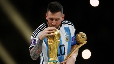 Argentina's Lionel Messi kisses the World Cup trophy after receiving the Golden Ball award as he celebrates after winning the World Cup. (Reuters)