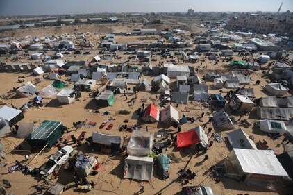Displaced Palestinians, who fled their houses due to Israeli strike, shelter in a camp in Rafah, amid the ongoing conflict between Israel and Palestinian Islamist group Hamas, in the southern Gaza Strip, December 6, 2023. (Reuters)