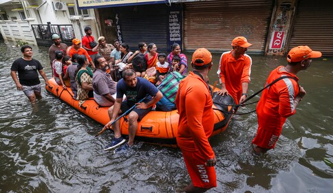 Emergency services personnel rescue stranded residents from a flooded colony after heavy rainfall owing to Cyclone Michaung in Chennai on Dec. 6. (pti) Emergency services personnel rescue stranded residents from a flooded colony after heavy rainfall owing to Cyclone Michaung in Chennai on Dec. 6. (pti)