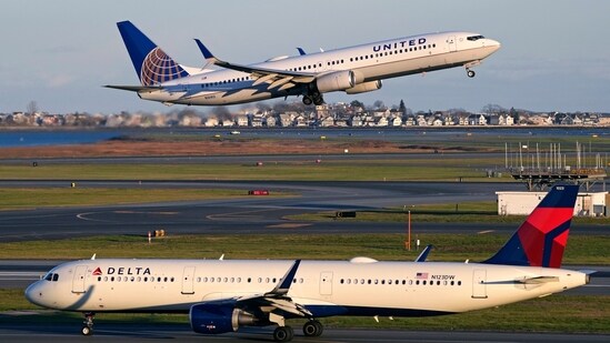 FILE - A United Airlines jet takes off while a Delta Airlines plane taxis at Logan International Airport, Monday, Nov. 21, 2022, in Boston. (AP Photo/Charles Krupa, File) (AP)