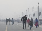 People take a stroll at Kartavya Path amid dense fog on a cold winter day in New Delhi. (ANI Photo)