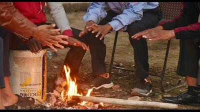 New Delhi , India - December 04 2023: People huddle around a bonfire to keep themselves warm amid a foggy morning and cold weather at Mayur vihar phase 1 Yamuna Khadar, in New Delhi , India on Monday, December 04 2023. (Photo by Sakib Ali /Hindustan Times) New Delhi , India - December 04 2023: People huddle around a bonfire to keep themselves warm amid a foggy morning and cold weather at Mayur vihar phase 1 Yamuna Khadar, in New Delhi , India on Monday, December 04 2023. (Photo by Sakib Ali /Hindustan Times)
