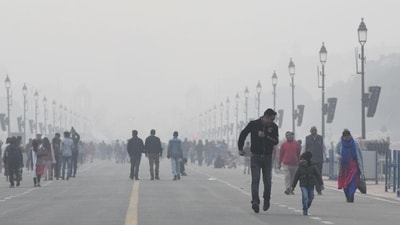 People take a stroll at Kartavya Path amid dense fog on a cold winter day in New Delhi. (ANI Photo) People take a stroll at Kartavya Path amid dense fog on a cold winter day in New Delhi. (ANI Photo)