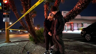 Sean Hathcock, right, kisses Michelle Ashley after the two left candles for victims of a shooting at the University of Nevada, Las Vegas, Wednesday, Dec. 6, 2023, in Las Vegas. The two graduated from the school and live nearby. (AP Photo/John Locher) Sean Hathcock, right, kisses Michelle Ashley after the two left candles for victims of a shooting at the University of Nevada, Las Vegas, Wednesday, Dec. 6, 2023, in Las Vegas. The two graduated from the school and live nearby. (AP Photo/John Locher)