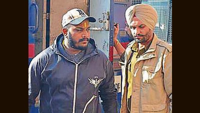 Ravinder Singh, alias Kali Shooter, in police custody in Mohali on Thursday. (HT Photo)