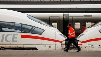 TOPSHOT - Employees walk past ICE highspeed trains that are standing still in the main train station of Munich, southern Germany, during a wage strike by German train drivers (AFP) TOPSHOT - Employees walk past ICE highspeed trains that are standing still in the main train station of Munich, southern Germany, during a wage strike by German train drivers (AFP)
