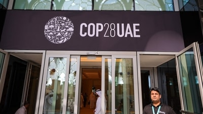 People walk past a COP28 sign at the venue of the United Nations climate summit in Dubai (AFP) People walk past a COP28 sign at the venue of the United Nations climate summit in Dubai (AFP)