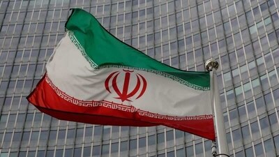 Iran nuclear deal: An Iranian flag flutters in front of the International Atomic Energy Agency (IAEA) headquarters in Vienna, Austria. (Reuters)