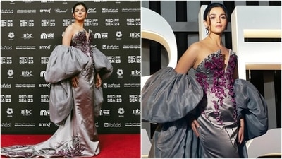 Alia chose a silver-coloured column gown featuring a strapless neckline with a front slit, a figure-hugging fitting, a floor-length hem, a train on the back, and sparkly purple floral applique embellishments with black-coloured vine designs. She paired the dress with matching voluminous sleeves draped on her arms. (Instagram) Alia chose a silver-coloured column gown featuring a strapless neckline with a front slit, a figure-hugging fitting, a floor-length hem, a train on the back, and sparkly purple floral applique embellishments with black-coloured vine designs. She paired the dress with matching voluminous sleeves draped on her arms. (Instagram)