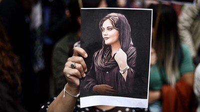 A protester holds a portrait of Mahsa Amini during a demonstration. (AFP) A protester holds a portrait of Mahsa Amini during a demonstration. (AFP)