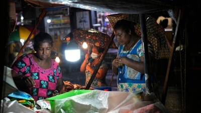 Sri Lanka Power Cuts: Women buy food from a roadside stall in Colombo, Sri Lanka. (AP) Sri Lanka Power Cuts: Women buy food from a roadside stall in Colombo, Sri Lanka. (AP)