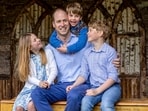 Prince William, the Prince of Wales, sits with his children Princess Charlotte, Prince Louis and Prince George