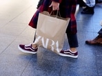 FILE PHOTO: A shopper carries a bag from Zara clothes store, part of the Spanish Inditex group, in Bilbao, Spain, November 30, 2021. REUTERS/Vincent West/File Photo