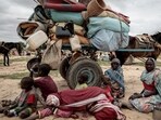 FILE PHOTO: A Sudanese family who fled the conflict in Murnei in Sudan's Darfur region, sit beside their belongings while waiting to be registered by UNHCR upon crossing the border between Sudan and Chad in Adre, Chad, July 26, 2023.      