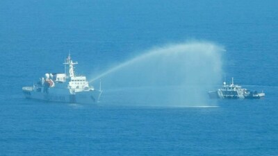 In this photo provided by the Philippine Coast Guard, a Chinese Coast Guard ship, left, uses its water cannons on a Philippine Bureau of Fisheries and Aquatic Resources (BFAR) vessel on December 9. (AP) In this photo provided by the Philippine Coast Guard, a Chinese Coast Guard ship, left, uses its water cannons on a Philippine Bureau of Fisheries and Aquatic Resources (BFAR) vessel on December 9. (AP)