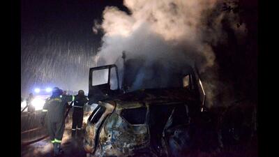 Firefighters at the spot after an SUV caught fire following a collision with a truck on the Bareilly-Nainital road, in Bareilly district, Saturday night. (PTI)