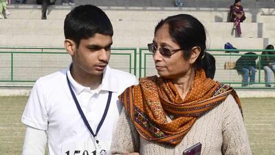 Yesheevardhan Rathore with his mother during the 24th Punjab State Special Olympics in Ludhiana. (Manish/HT ) Yesheevardhan Rathore with his mother during the 24th Punjab State Special Olympics in Ludhiana. (Manish/HT )