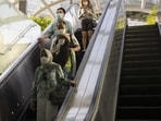 Singapore Coronavirus: Shoppers ride an escalator on Orchard Road in Singapore.