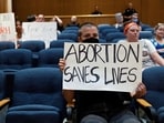 FILE PHOTO: A few abortion rights demonstrators remain in the crowd after hours of public comments and discussion as Denton’s city council meets to vote on a resolution seeking to make enforcing Texas’ trigger law on abortion a low priority for its police force, in Denton, Texas, June 28, 2022. REUTERS/Shelby Tauber/File Photo