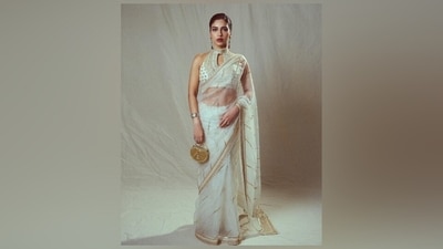 Bhumi wore the six yards with a sleeveless white blouse featuring a raised halter neckline, keyhole cut-out on the decolletage, gold gota patti embroidery in a floral pattern, a fitted bust, cropped hem exposing her toned midriff, and a backless design. (Instagram) Bhumi wore the six yards with a sleeveless white blouse featuring a raised halter neckline, keyhole cut-out on the decolletage, gold gota patti embroidery in a floral pattern, a fitted bust, cropped hem exposing her toned midriff, and a backless design. (Instagram)