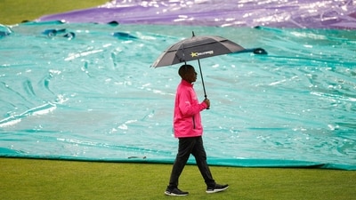 A match official inspects the pitch after rain delayed the start of play ahead of the first T20 cricket match between South Africa and India (AFP) A match official inspects the pitch after rain delayed the start of play ahead of the first T20 cricket match between South Africa and India (AFP)