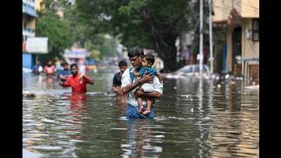 People wade through a flooded street after heavy rains in Chennai on December 6. (AFP) People wade through a flooded street after heavy rains in Chennai on December 6. (AFP)