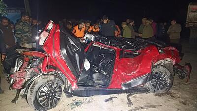 The mangled remains of the sport utility vehicle that was dragged by a truck-trailer on the Jammu-Pathankot highway on Sunday. The trailer overturned on the SUV, leading to the death of both its occupants. (HT Photo)