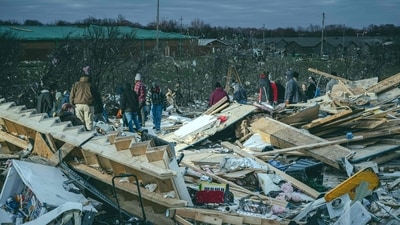 CLARKSVILLE, TENNESSEE - DECEMBER 10: Residents and visitors work to clear debris in search of pets and belongings of a destroyed home in the aftermath of a tornado on December 10, 2023 in Clarksville, Tennessee. Multiple long-track tornadoes were reported in northwest Tennessee on December 9th causing multiple deaths and injuries and widespread damage. Jon Cherry/Getty Images/AFP (Photo by Jon Cherry / GETTY IMAGES NORTH AMERICA / Getty Images via AFP) (Getty Images via AFP) CLARKSVILLE, TENNESSEE - DECEMBER 10: Residents and visitors work to clear debris in search of pets and belongings of a destroyed home in the aftermath of a tornado on December 10, 2023 in Clarksville, Tennessee. Multiple long-track tornadoes were reported in northwest Tennessee on December 9th causing multiple deaths and injuries and widespread damage. Jon Cherry/Getty Images/AFP (Photo by Jon Cherry / GETTY IMAGES NORTH AMERICA / Getty Images via AFP) (Getty Images via AFP)