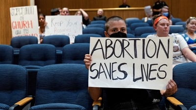FILE PHOTO: A few abortion rights demonstrators remain in the crowd after hours of public comments and discussion as Denton’s city council meets to vote on a resolution seeking to make enforcing Texas’ trigger law on abortion a low priority for its police force, in Denton, Texas, June 28, 2022. REUTERS/Shelby Tauber/File Photo (REUTERS)