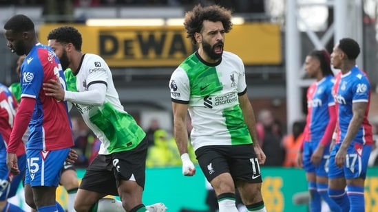 Liverpool's Mohamed Salah, centre, celebrates after scoring his side's opening goal during the Premier League soccer match between Crystal Palace and Liverpool at Selhurst Park (AP)