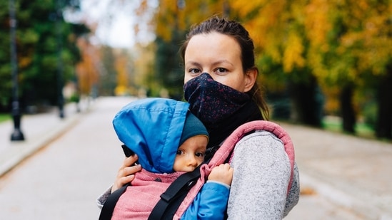 Wear Your Baby for Warmth: Utilizing a baby carrier in cold weather transfers your body heat to your baby, offering additional warmth and coziness. Be attentive to covering their head and feet, as these areas are where they tend to lose heat.&nbsp;(Unsplash)
