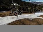 A chair lift transports skiers over dry ground and a narrowed ski run at La Molina ski resort in Girona, Spain. A chair lift transports skiers over dry ground and a narrowed ski run at La Molina ski resort in Girona, Spain.
