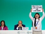 Licypriya Kangujam, an Indigenous climate activist from India, holds a banner during the United Nations Climate Change Conference (COP28) in Dubai, United Arab Emirates, on December 11. (REUTERS)
