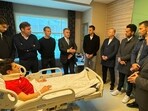 Turkish Minister of Youth and Sports Osman Askin Bak (CL) visiting Turkish referee Halil Umut Meler (bottom) who was hospitalised after being punched by the President of MKE Ankaragucu Football Club, Faruk Koca, in Ankara