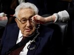 FILE PHOTO: A Code Pink demonstrator dangles a set of handcuffs in front of former United States Secretary of State Henry Kissinger at the Armed Services Committee on global challenges and U.S. national security strategy on Capitol Hill in Washington, U.S. January 29, 2015. REUTERS/Gary Cameron/File Photo