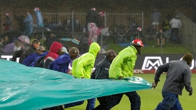Rain made an appearance with three balls left in that over and the players rushed back into the dressing room with India's score reading 180/7 in 19.3 overs. (AP) Rain made an appearance with three balls left in that over and the players rushed back into the dressing room with India's score reading 180/7 in 19.3 overs. (AP)