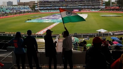An India supporter waves a flag while covers are visible on the pitch | Image for representation (AFP) An India supporter waves a flag while covers are visible on the pitch | Image for representation (AFP)