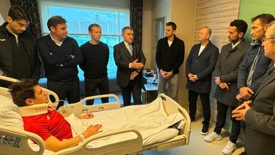 Turkish Minister of Youth and Sports Osman Askin Bak (CL) visiting Turkish referee Halil Umut Meler (bottom) who was hospitalised after being punched by the President of MKE Ankaragucu Football Club, Faruk Koca, in Ankara (AFP)