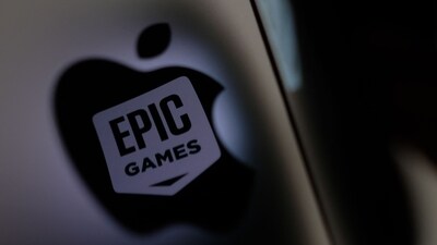(FILES) This illustration photo shows the Epic Games logo reflecting onto the Apple logo of the back of an I-mac in Los Angeles on May 3, 2021. (AFP) (FILES) This illustration photo shows the Epic Games logo reflecting onto the Apple logo of the back of an I-mac in Los Angeles on May 3, 2021. (AFP)