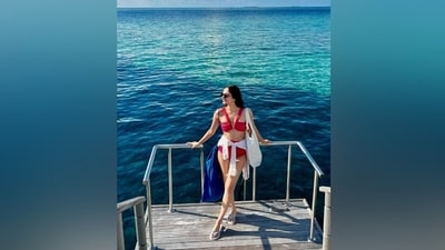 Manushi ditched all accessories to style the bikini set. She just opted for a pair of black tinted sunglasses, flip flops, a white tote bag, and a crisp white plain shirt to tie on her waist. Lastly, centre-parted open wavy locks rounded off her beach look. (Instagram) Manushi ditched all accessories to style the bikini set. She just opted for a pair of black tinted sunglasses, flip flops, a white tote bag, and a crisp white plain shirt to tie on her waist. Lastly, centre-parted open wavy locks rounded off her beach look. (Instagram)