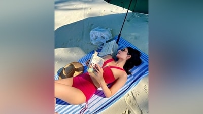 While the sleeveless top features a plunging V halter neckline with a metal embellishment, a gathered design, curved hem, and a fitted bust, the bikini bottoms have a high-rise waist, high-leg cutouts, a matching gathered pattern, and ribbon ties on the sides. (Instagram) While the sleeveless top features a plunging V halter neckline with a metal embellishment, a gathered design, curved hem, and a fitted bust, the bikini bottoms have a high-rise waist, high-leg cutouts, a matching gathered pattern, and ribbon ties on the sides. (Instagram)